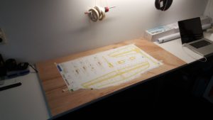Plans are cut out and pinned to build table